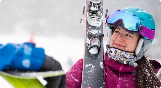 Woman holding skis